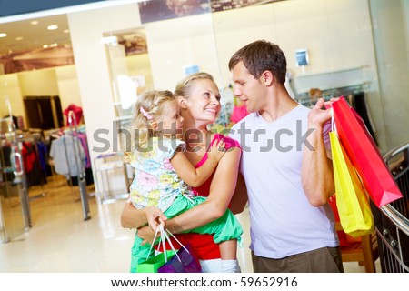 Portrait of happy family spending free time in department store