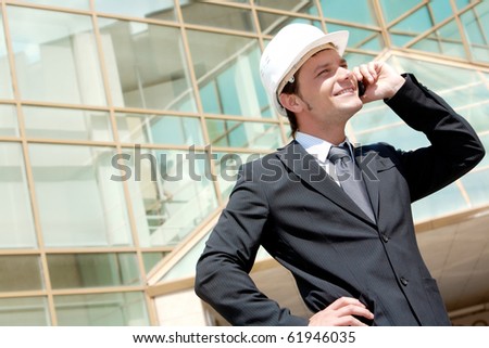 Portrait of confident smiling foreman calling by the phone