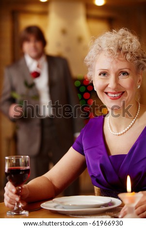 Moment before meeting: woman waiting her man in the restaurant