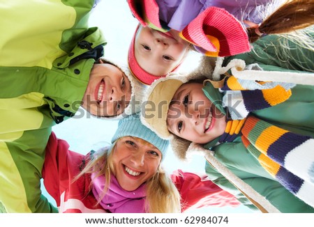 Below angle of happy family looking at camera