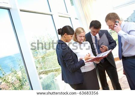 Image of business people consulting during paperwork