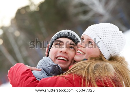 Portrait of happy couple looking upwards while embracing