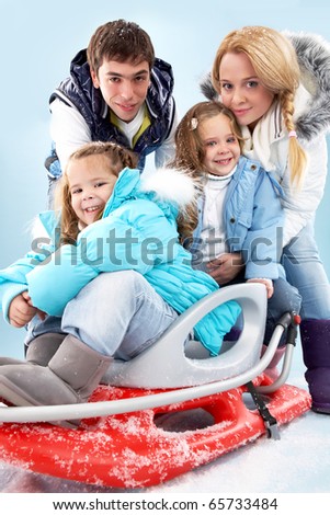Happy family members in winter clothes looking at camera