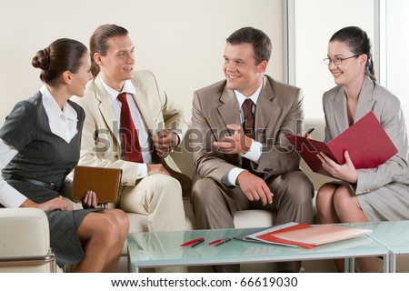Portrait of business people sitting next to each other and communicating at business meeting