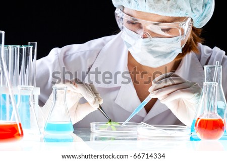 Close-up of clinician working with tools during scientific experiment in laboratory