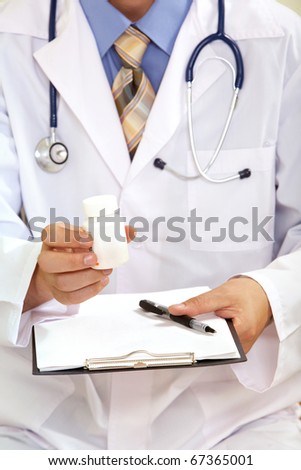 Close-up of doctor?s hand holding medicine and giving it to his patient