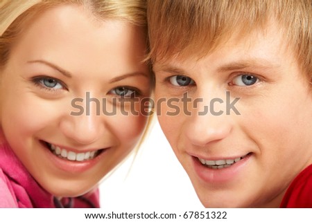 Happy faces of young girl and guy looking at camera and smiling