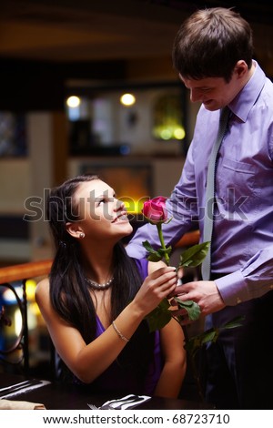 Image of man giving a red rose to his girlfriend