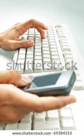 Close-up of female hands by keyboard pressing buttons of palmtop device