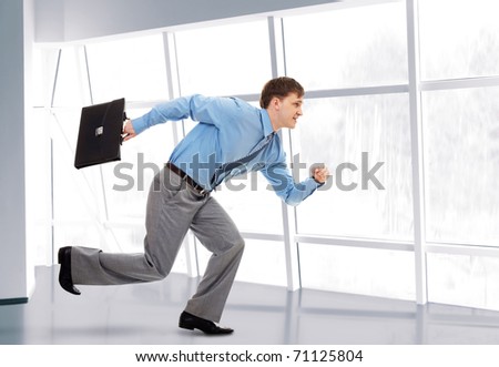 A running businessman with briefcase