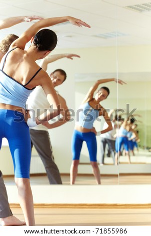 stock photo Portrait of young sporty girl and guy doing physical exercise