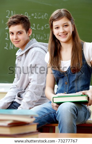 Portrait of happy guy and girl looking at camera