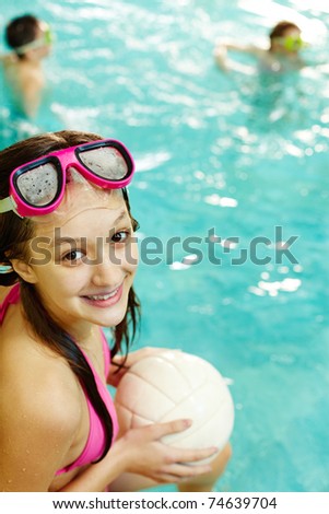 Photo of happy girl with ball smiling at camera