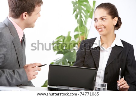 Boss and secretary discussing plan at meeting in office