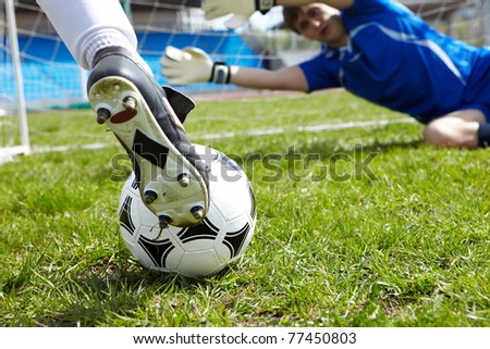 Horizontal image of soccer ball with foot of player kicking it Horizontal image of soccer ball with foot of player kicking it