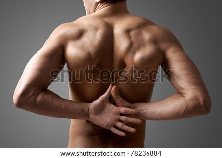 Back view of handsome man with hands behind