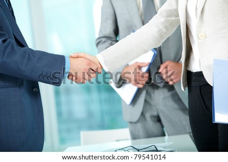 Photo of handshake of business partners after striking deal on background of man