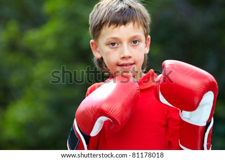 Portrait of a little boy in boxing gloves