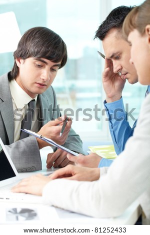 Three business people thinking together over a task