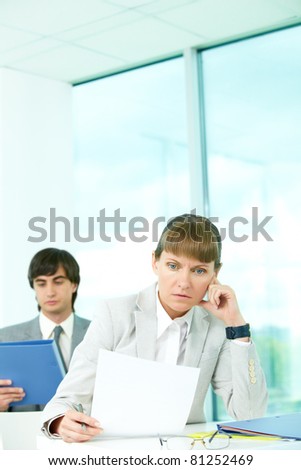 A woman manager looking at paper in surprise