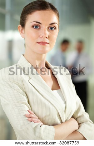 Portrait of serious businesswoman looking at camera in working environment