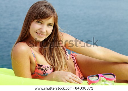 stock photo Portrait of teenage girl in bikini lying on mattress and 