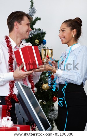 Image of happy businesswoman making present to ceo at corporate party