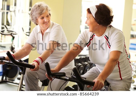 Two senior women training in health club