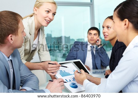 Businesswoman explaining business plan to her colleagues