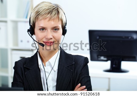 Portrait of customer service operator with headset looking at camera