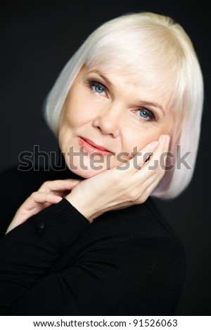 stock photo Portrait of mature blond female looking at camera