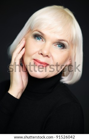 stock photo Portrait of mature blond female looking at camera