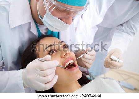 Dentist and his assistant carrying out a thorough examination