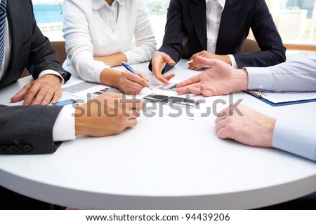 Image of business people hands working with papers at meeting Image of business people hands working with papers at meeting