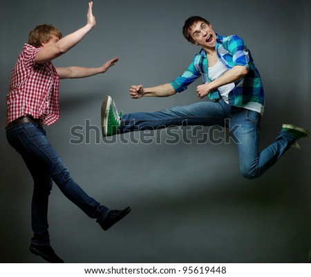 Guy jumping into air and kicking his friend, foolÃ¢Â?Â?s day series
