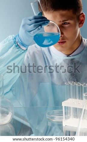 Scientific researcher or student looking closely at the result of the experiment