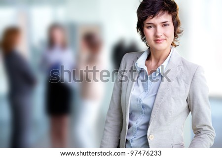 Image of elegant female looking at camera in working environment