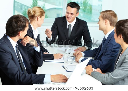 Image of confident boss voicing his ideas at meeting