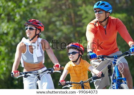Portrait of happy family riding on bicycles at leisure