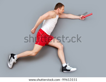 Sportive guy hurrying to pass the relay baton