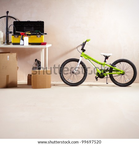 Image of mountain bike and some equipment in garage