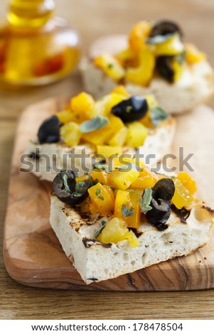 Italian snack with black olives, capsicum and herbs