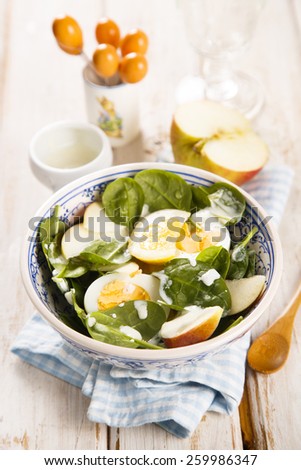 Spinach salad with hard boiled eggs and apple
