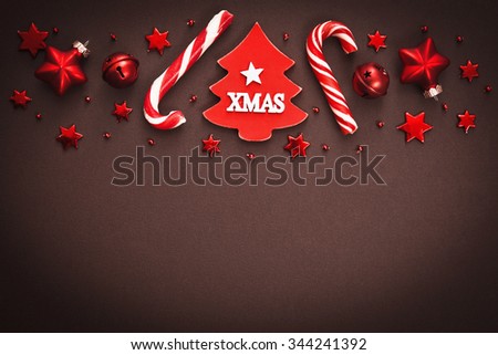 Christmas candy and decorations on brown background