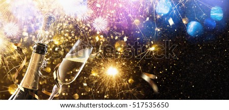 New Year\'s fireworks with glasses of champagne. Holiday background