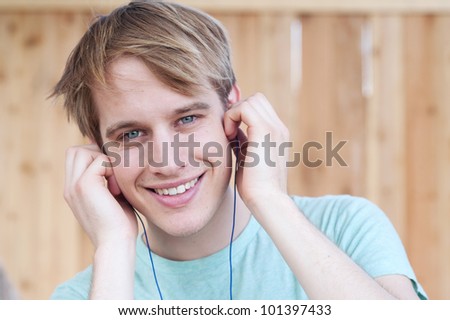 closeup of young male listening to music outside