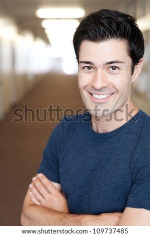 portrait of a handsome young male student inside a school