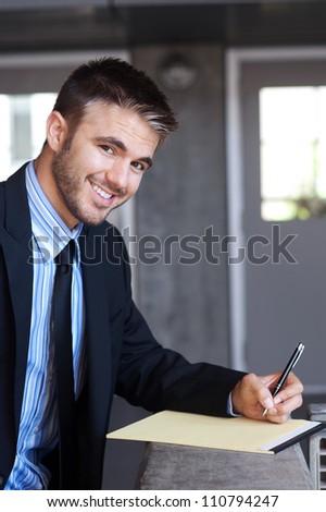 portrait of a handsome young businessman outside