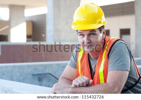 portrait of a mature construction worker outside with hard hat