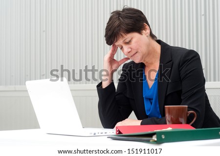 businesswoman under stress, fatigue, and headache at office